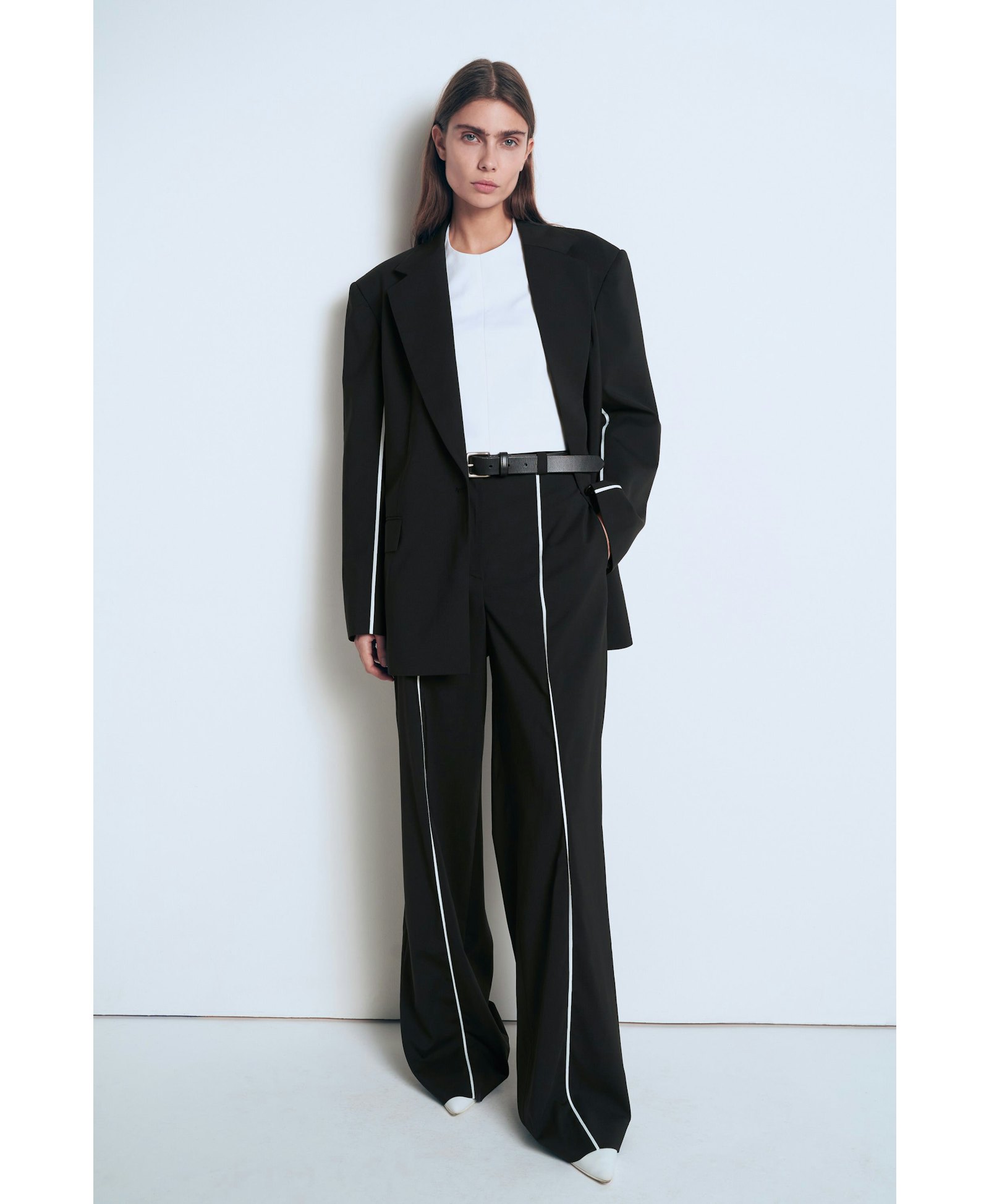 Black jacket with white piping made by A.M.G