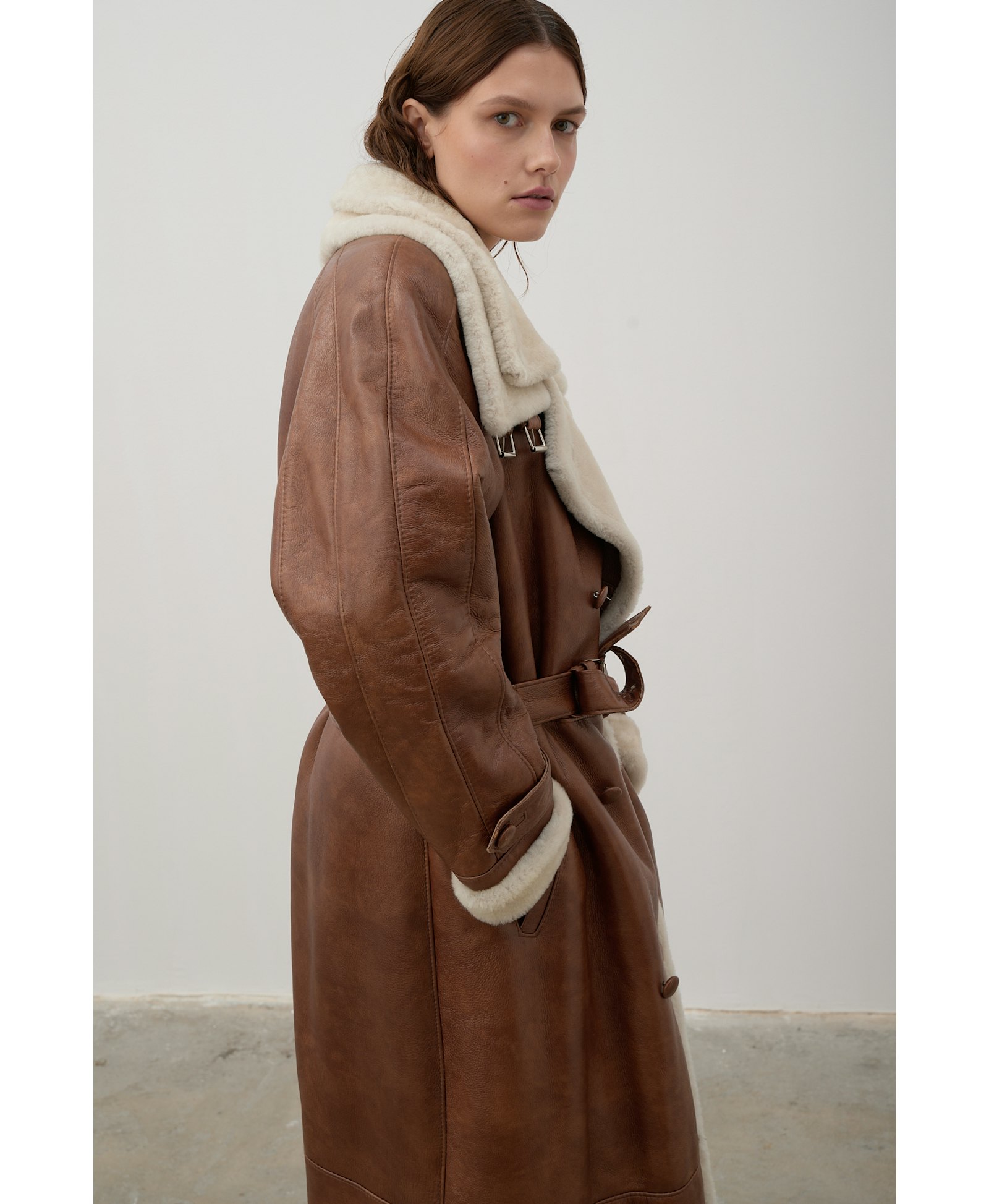 Long, caramel-colored sheepskin coat made by Karen Arcanjo