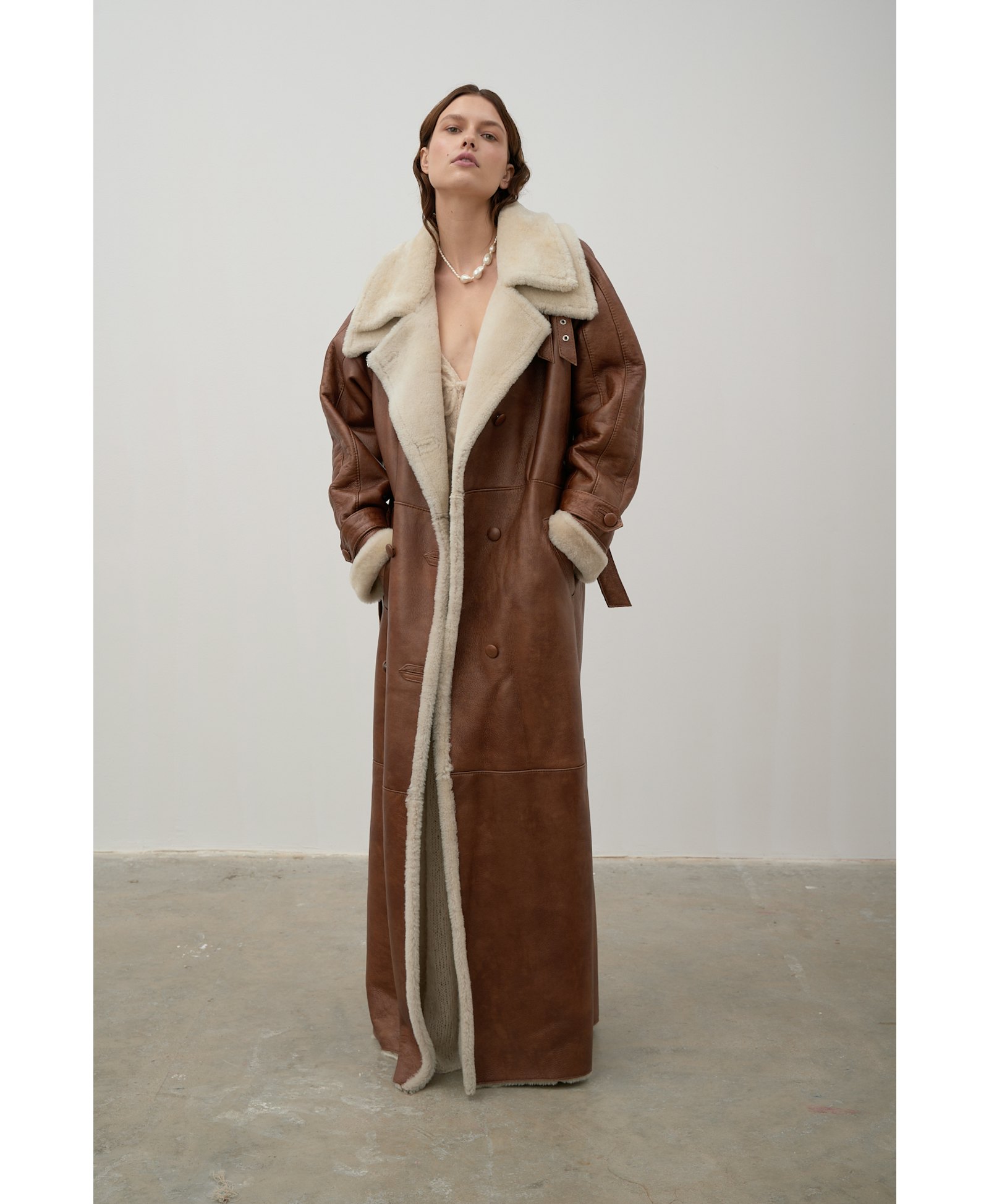 Long, caramel-colored sheepskin coat made by Karen Arcanjo