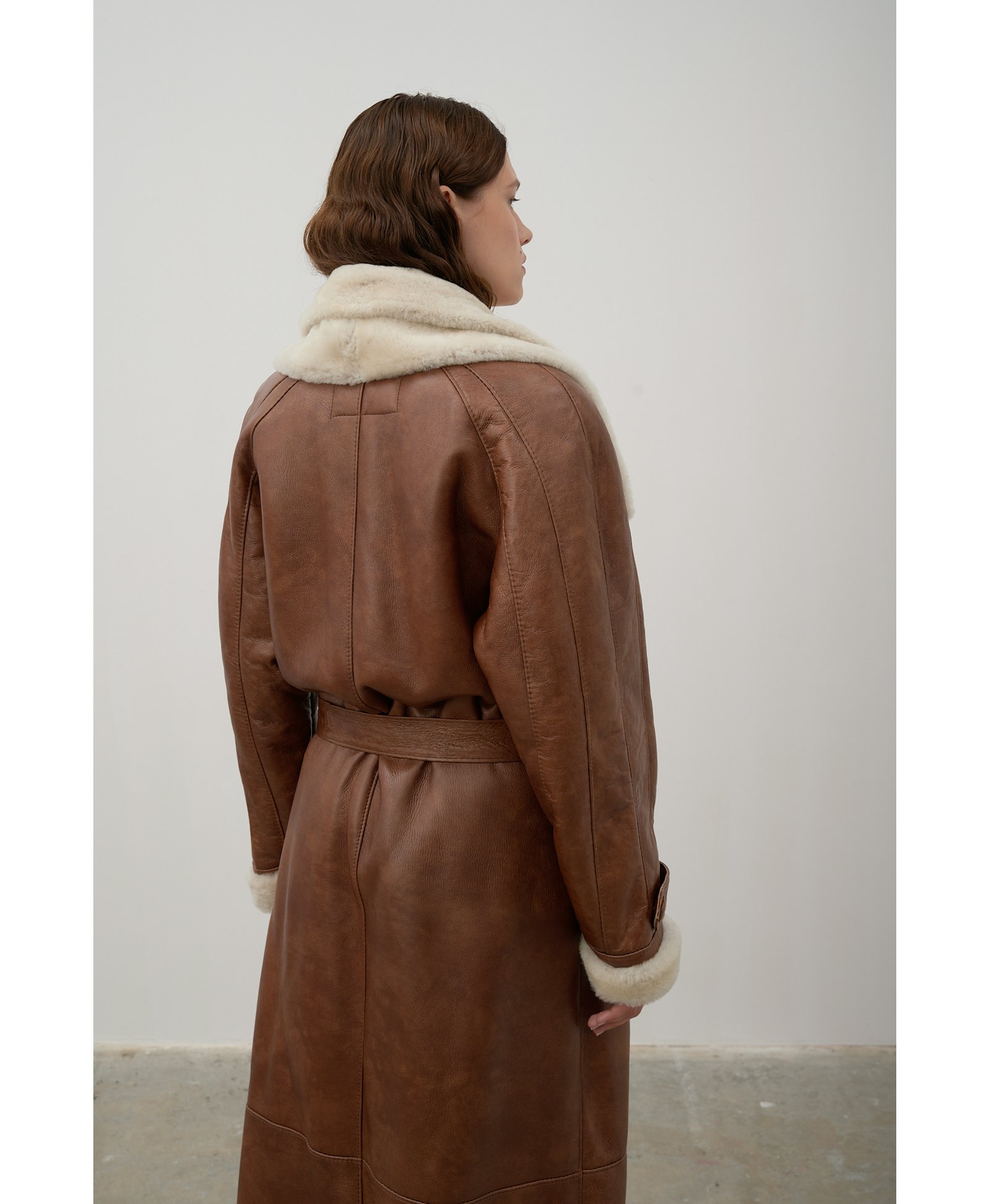 Long, caramel-colored sheepskin coat made by Karen Arcanjo