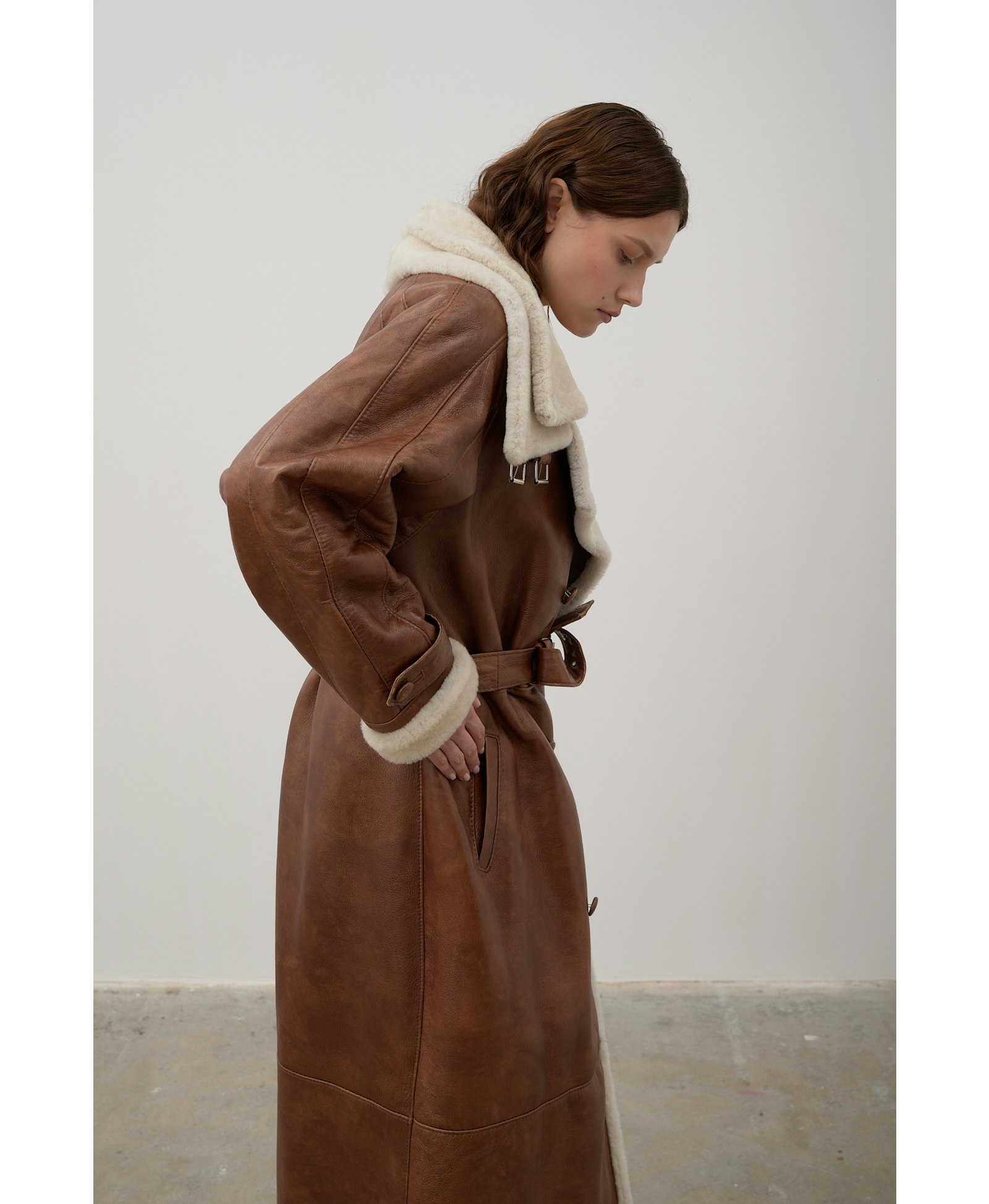 Long, caramel-colored sheepskin coat made by Karen Arcanjo