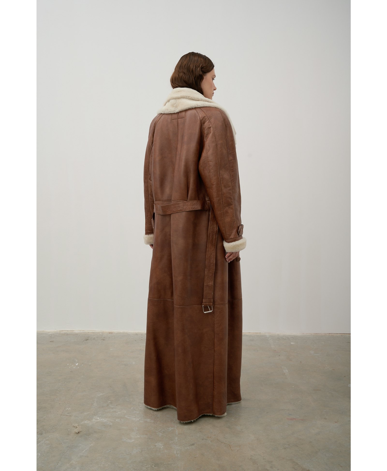 Long, caramel-colored sheepskin coat made by Karen Arcanjo