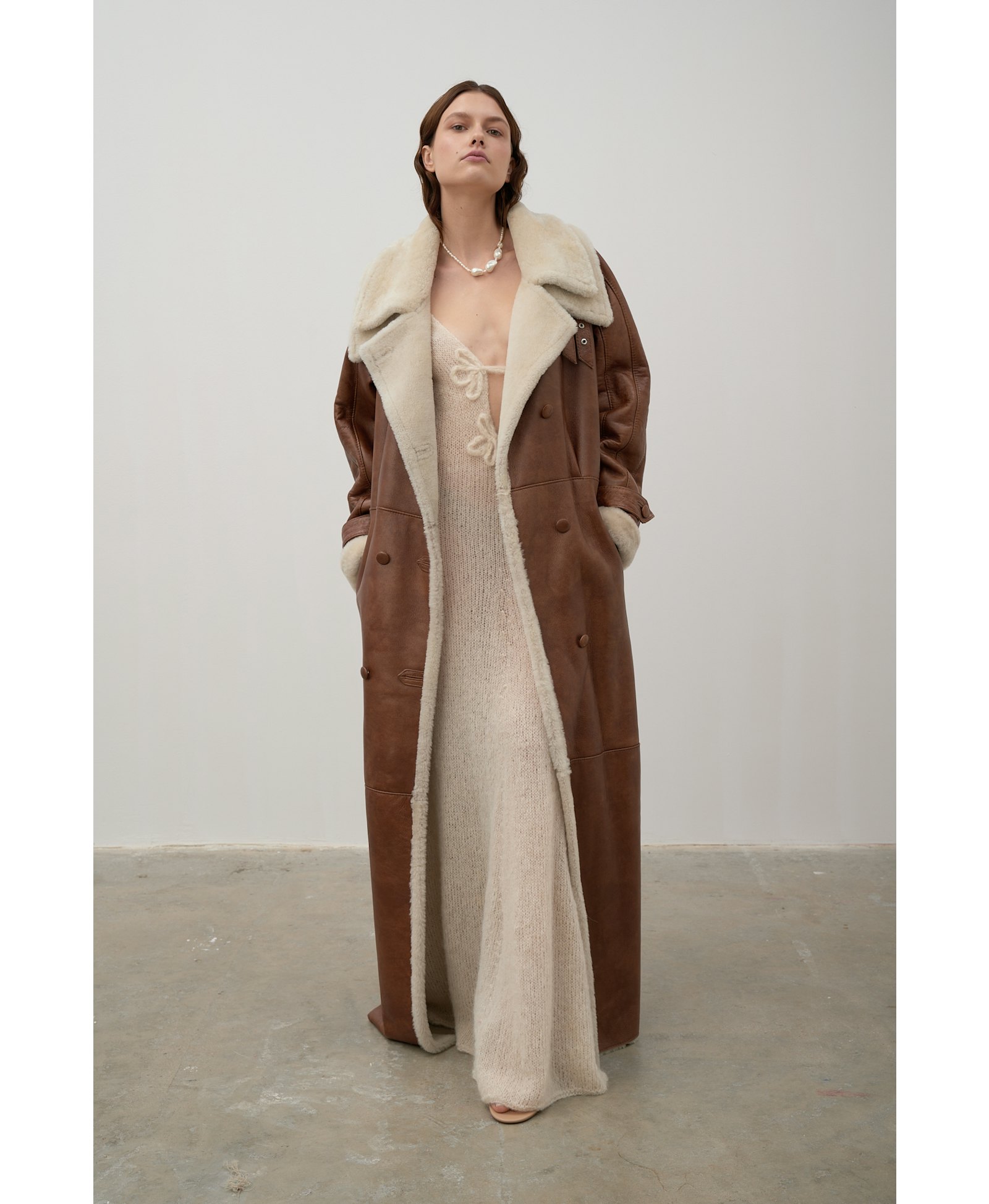 Long, caramel-colored sheepskin coat made by Karen Arcanjo