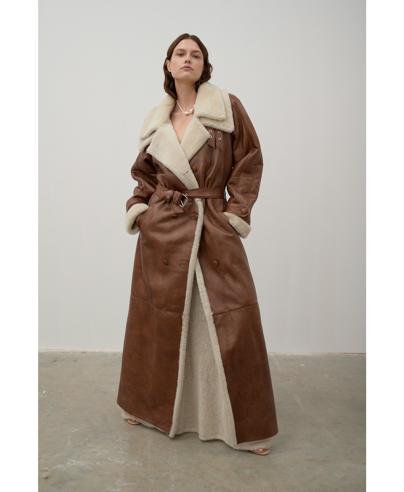 Long, caramel-colored sheepskin coat made by Karen Arcanjo